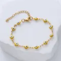 Close-up of yellow evil eye stainless steel bracelet on white rock prop - Yellow