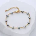 Detailed view of gold-plated stainless steel bracelet with black enamel evil eye charms - Black