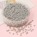 Detailed shot of small silver metallic glass seed beads for DIY jewelry making projects - 2.0mm / 10g/Pack (Approx 1000 Pcs) / Silver Plated