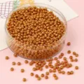 Detailed macro view of shimmering golden glass seed beads for handmade DIY jewelry crafting - 2.0mm / 10g/Pack (Approx 1000 Pcs) / Deep Gold