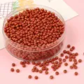 Shimmering metallic orange glass seed beads for DIY jewelry making in clear storage tub - Silver Orange Red