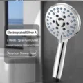Detailed view of a multi-functional chrome shower head with blue high-pressure nozzles - American shower plating
