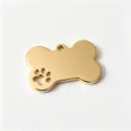 Detail of a gold bone-shaped stainless steel pet ID tag with a paw print cutout. - Gold