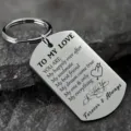 Detailed view of engraved inspirational dog tag keychain on a dark stone background - English To My Love (ALYSK-0024-3)