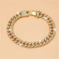 Detail view of a luxury iced out gold Cuban link chain necklace with sparkling rhinestones - 18cm / Gold