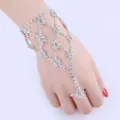 Detailed view of a silver-tone rhinestone hand chain bracelet with an integrated ring - Mesh Hand Chain Bracelet / Silver