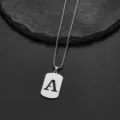 Detail view of a silver stainless steel necklace with letter A pendant on rock background - Letter A