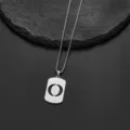Close-up of stainless steel necklace with letter O cutout rectangular pendant - Letter O