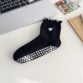 Black mid-tube yoga socks with white anti-slip dots and cute heart embroidery detail. - Black