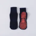 Dunkelblaue Trampolinsocken mit orangefarbenen rutschfesten Gummigriffen für alle - Marineblau