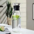 Clear glass cold water pitcher with black lid, excellent for home fruit juice and tea. - Cylindrical Style With Sleeve / 1500ml