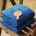 Soft blue coral fleece bath towel with vertical stripes on a wooden chair. - 80*150cm / Navy Blue