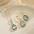 Close-up of elegant bridal jewelry set with blue teardrop pendants and gold filigree - Teardrop Pendant / Green