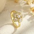 Macro detailed view of elegant gold-plated flower ring featuring a rotating pearl center - White Petal Style (80343) / Open Adjustable