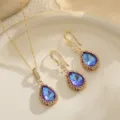Detailed macro view of an elegant waterdrop blue crystal necklace and earrings set - Teardrop Pendant / Purple