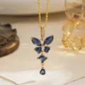 Close-up of gold butterfly pendant featuring deep blue sapphire-like stones. - Pendant Only (With Stainless Steel Chain) / Blue
