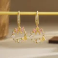 Detailed shot of gold-plated wreath earrings with pink cubic zirconia bows and butterflies - Butterfly Garland Style (80426) / Pink