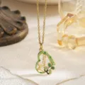Detailed macro view of a gold-plated heart pendant with green enamel and Mama lettering - Green (With Chain)