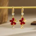Detailed macro shot of vintage gold drop earrings featuring red zircon flowers and gems - Flower and Butterfly Style (80433) / Retro Copper