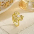 Close-up of elegant gold rotating flower ring with pearl center and crystals. - Full Rhinestone Petal Style (80366) / Open Adjustable