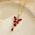 Detailed view of an elegant vintage gold necklace with ruby-red zircon floral pendant - Pendant Necklace (80490) / Red