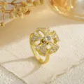 Close-up of golden rotating fidget ring with shimmering cubic zirconia stones - Four-leaf Clover (80367) / Open Adjustable / Gold