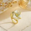 Detail of a rotating flower ring featuring gold plating and sparkling zircon stones - Enamel Flower Style (80370)