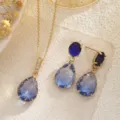 Detailed shot of blue waterdrop crystal necklace and earrings jewelry set in gold finish - Jewelry Set (10029) / Deep Blue Gradient