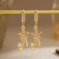 Close-up detail of gold-plated star earrings with pink zircon and shooting star - Meteor Star Style (80495) / Pink