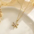 Detailed close-up of a gold snowflake pendant necklace adorned with clear cubic zirconia - Rotatable Snowflake Style (80474)