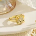 Detail view of a gold cat spinner ring encrusted with sparkling cubic zirconia stones - Rhinestone Cat Head Style (80395) / Gold