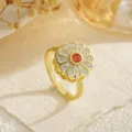 Detailed close-up of a golden rotatable flower ring with orange and white crystals - Orange-Red Center Stone Sunflower Style (80411) / Open Adjustable