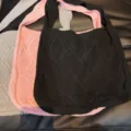 Close-up of vintage knitted tote bags with diamond pattern in black, pink, and grey - Black