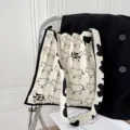 Elegante borsa a tracolla in maglia plissettata bianca e nera con motivo a mucca unico - Mucca Carina