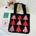 Close-up of a festive black knitted tote bag featuring red and white Christmas tree patterns - 32*36cm / Black