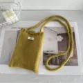Hand-knitted mustard yellow crochet crossbody phone bag with minimalist egg brand tag - Turmeric