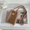 Handmade brown crochet crossbody phone bag with knitted strap and cute egg tag detail - Khaki