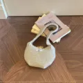Elegant beige knitted mini handbag with wooden button closure on a decorative background - Toggle Button Knit Bag / Khaki / 14x15cm