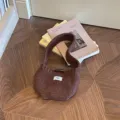 Stylish brown knitted wool clutch bag featuring a white egg label on a wooden parquet floor - Toggle Button Knit Bag / Coffee / 14x15cm