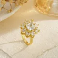 Close-up of a sparkling gold-plated snowflake ring with clear cubic zirconia - Square Gem Flower Style (80394)