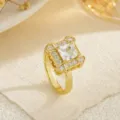 Macro detail of a gold rotatable copper ring featuring a sparkling square zircon center stone. - Luxury Square Pave Style (80399)