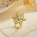 Detailed macro view of a rotating gold snowflake ring with sparkling zircon stones - Dimensional Snowflake Style (80405)