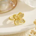 Detail of gold brass ring featuring micro-pave zirconia four-leaf clover design. - 3D Hollow White Zirconia Clover Style (80425)
