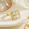 Detailed close-up of a rotating gold clover ring featuring marquise-cut sparkling zircons - Square Frame Clear Zirconia Clover Style (80435)