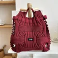 Close-up of a burgundy pleated knitted handbag with a unique architectural texture - Wave Texture Style / Burgundy