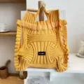 Detail of yellow pleated knitted handbag with unique structured designer style - Wave Texture Style / Turmeric
