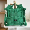 Detailed view of green knitted woven handbag featuring unique ruffled texture and niche design - Wave Texture Style / Green