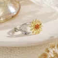 Detailed view of a two-tone sunflower spinner ring with orange stones and silver leaves. - Sunflower Spinner Ring (80477) / Two-Tone Gold & Orange Red