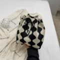 Chic black and white wavy pattern knitted bucket bag with a stylish drawstring closure - Black Wave