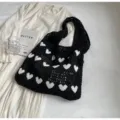 Black handmade knitted tote bag with white heart patterns and a hollow mesh design style - Black